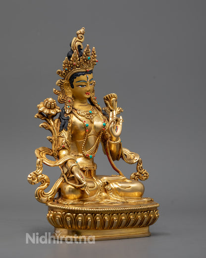 Intricately crafted hands of the White Tara statue in varada (giving) and abhaya (protection) mudras, embellished with gold and coral inlays.