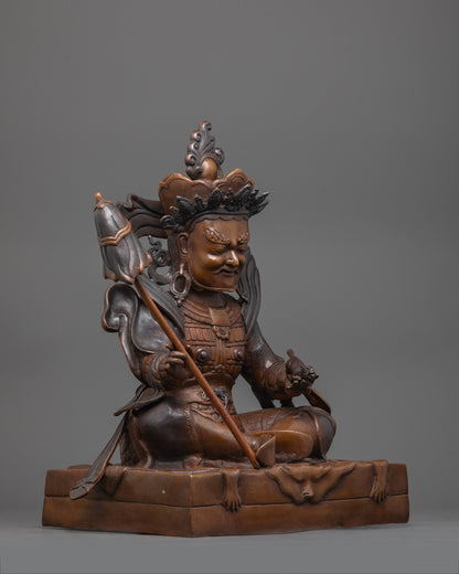 Intricately detailed Virupaksa figure made from oxidized copper, seated on a plain base