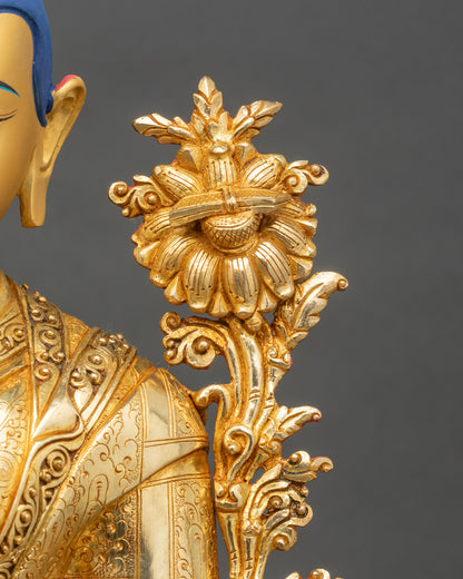 Je Tsongkhapa statue in meditation pose with elegant lotus stems on sides