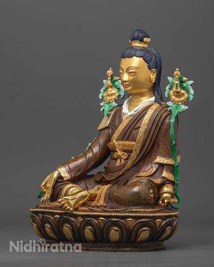 Jigme Lingpa statue holding an Utpala flower, symbolizing pure wisdom in Tibetan Buddhist art.