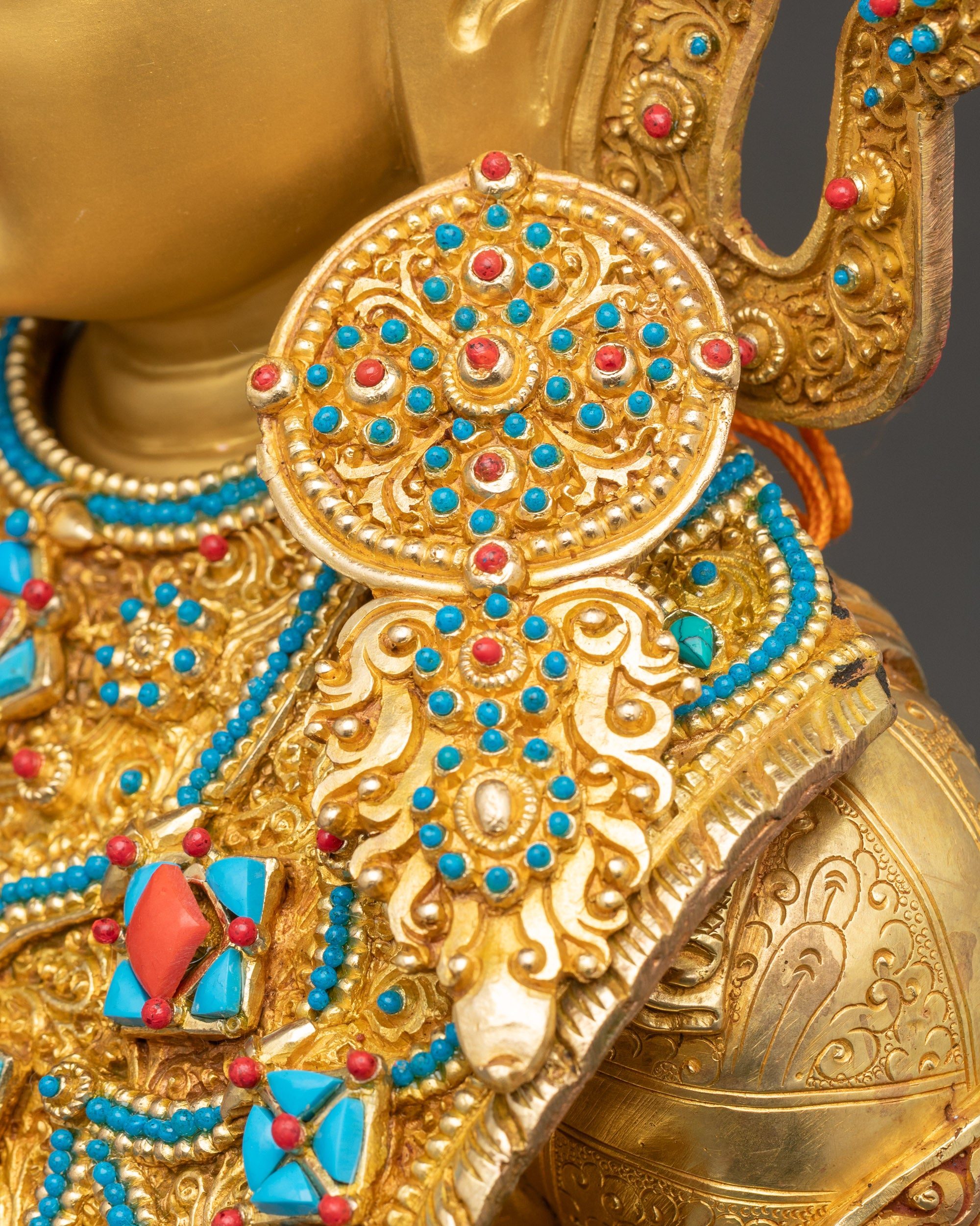 Close-up of intricate 3D carvings on Jowo Buddha Statue, handcrafted copper with triple gold fire-gilding.