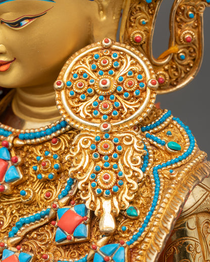 Detailed close-up of ornate earrings on Jowo Shakyamuni Rinpoche Statue, showcasing fine Newari craftsmanship