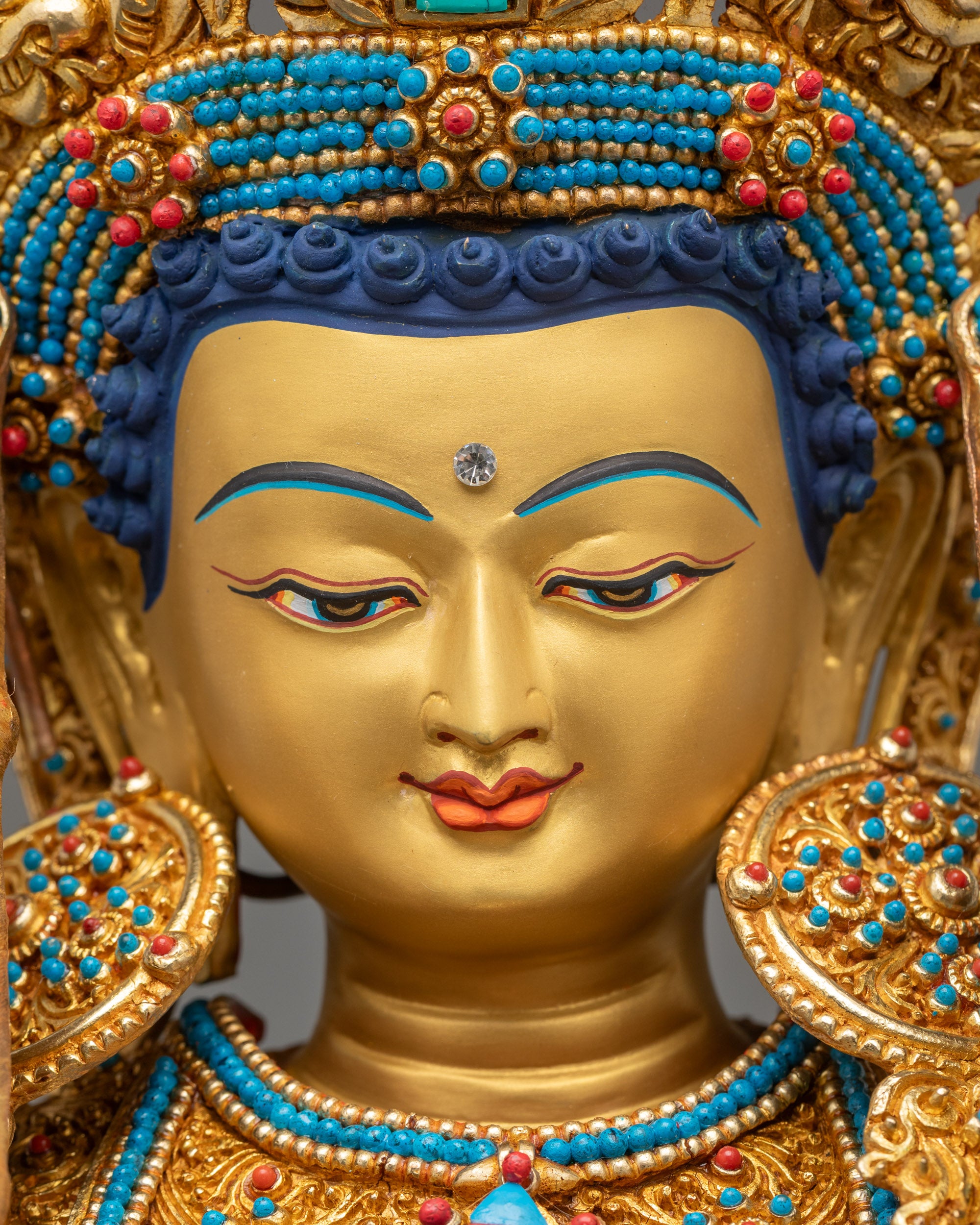 Close-up of Jowo Shakyamuni Rinpoche’s serene gold-painted face showing tranquil gaze
