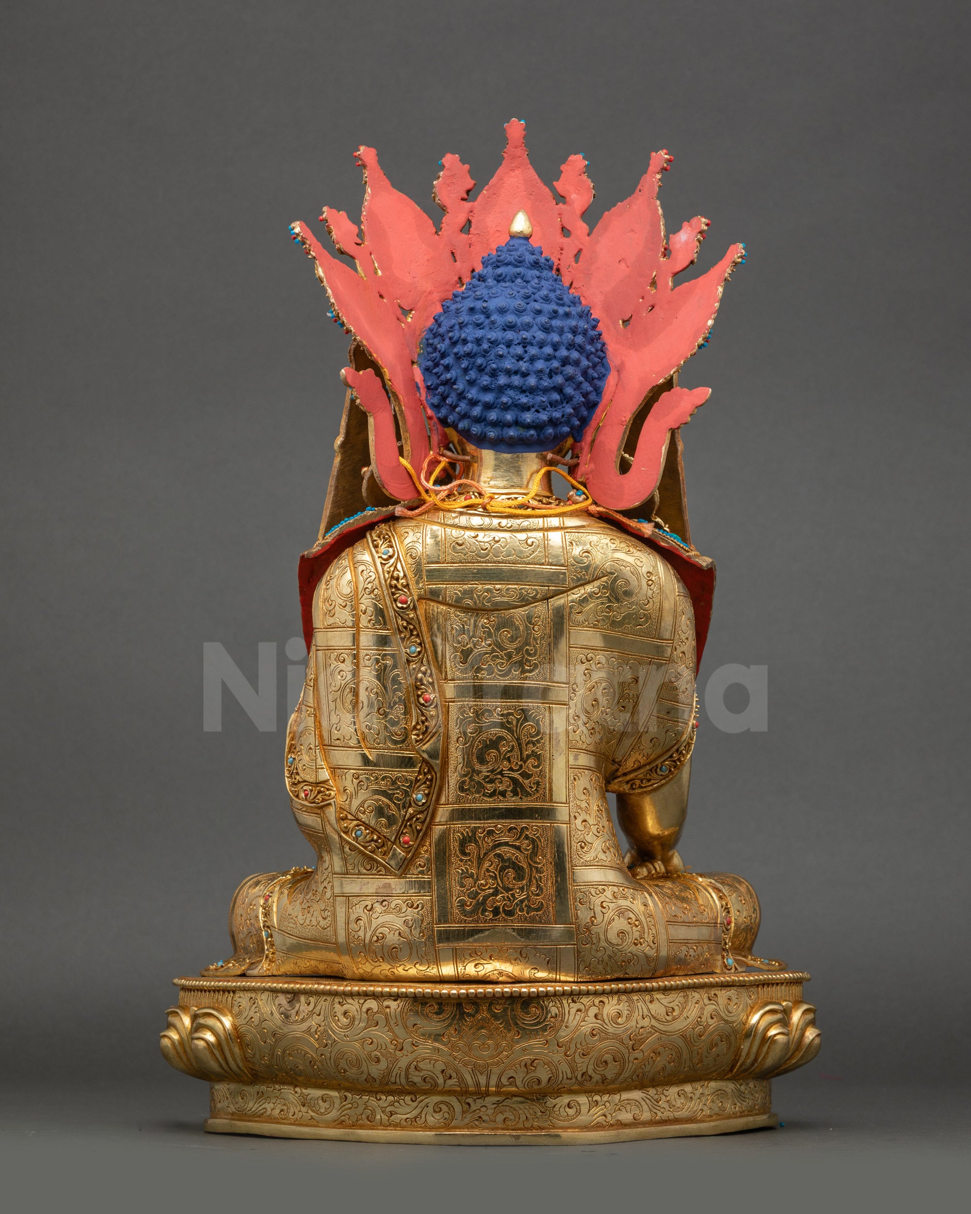 Carved monk robe detail on Jowo Shakyamuni Rinpoche statue with floral patterns