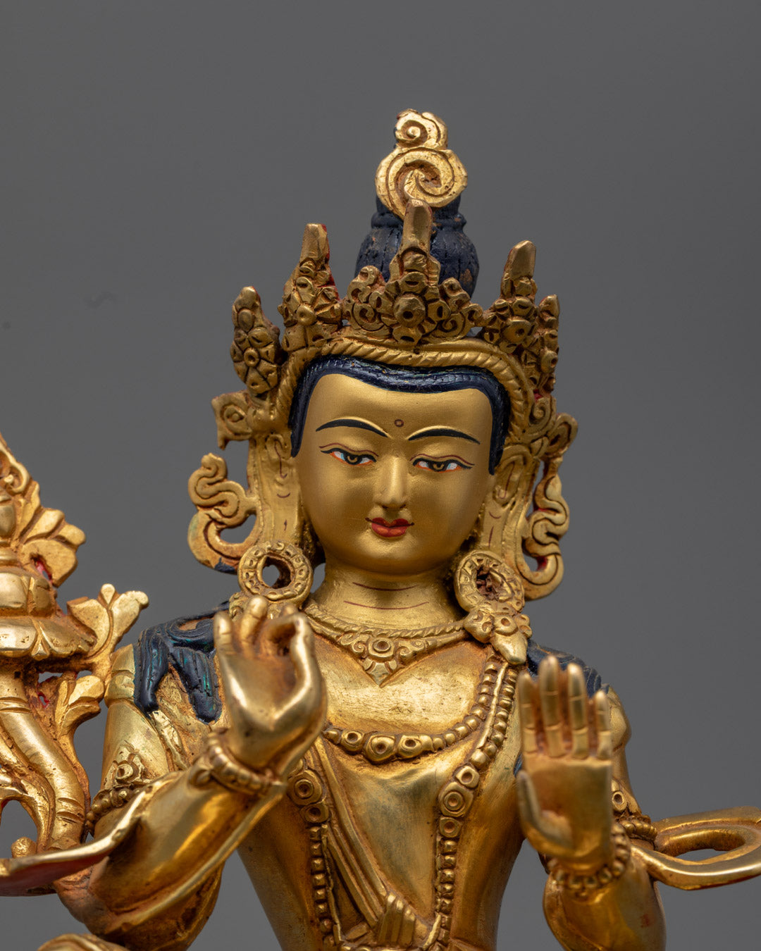 Kṣitigarbha holding an utpala flower, showcasing hand-painted acrylic details and sacred symbolism