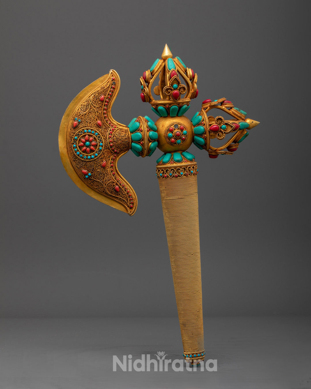 Side angle of handcrafted Kartika Axe showing detailed copper and gemstone work