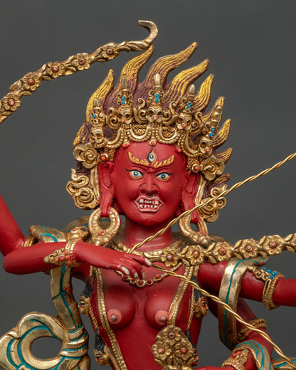 Close up of Kurukulla Statue gold painted face four arms sacred Buddhist deity