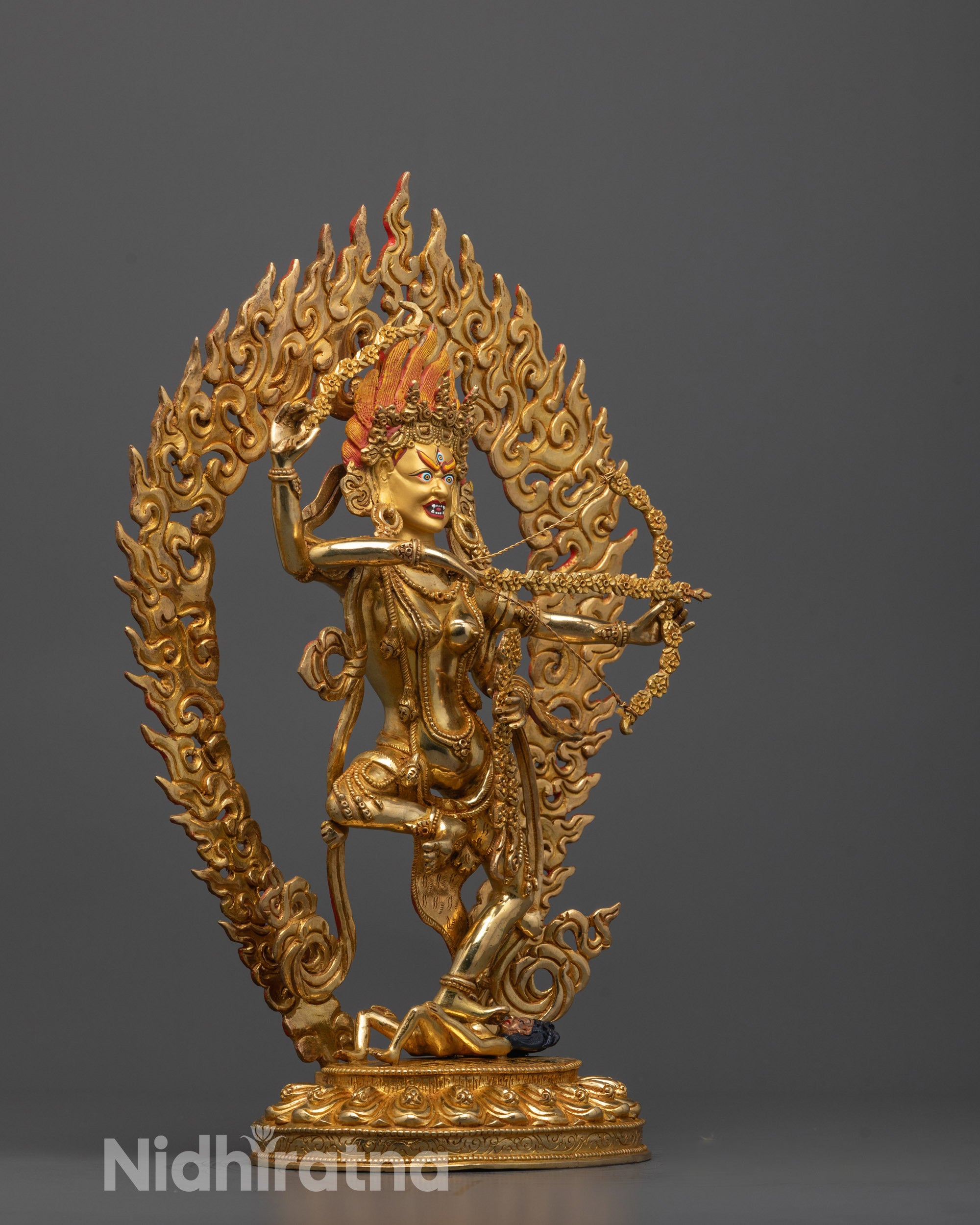 Side view of Kurukulla Statue showing skull crown, malas, and glowing radiant halo