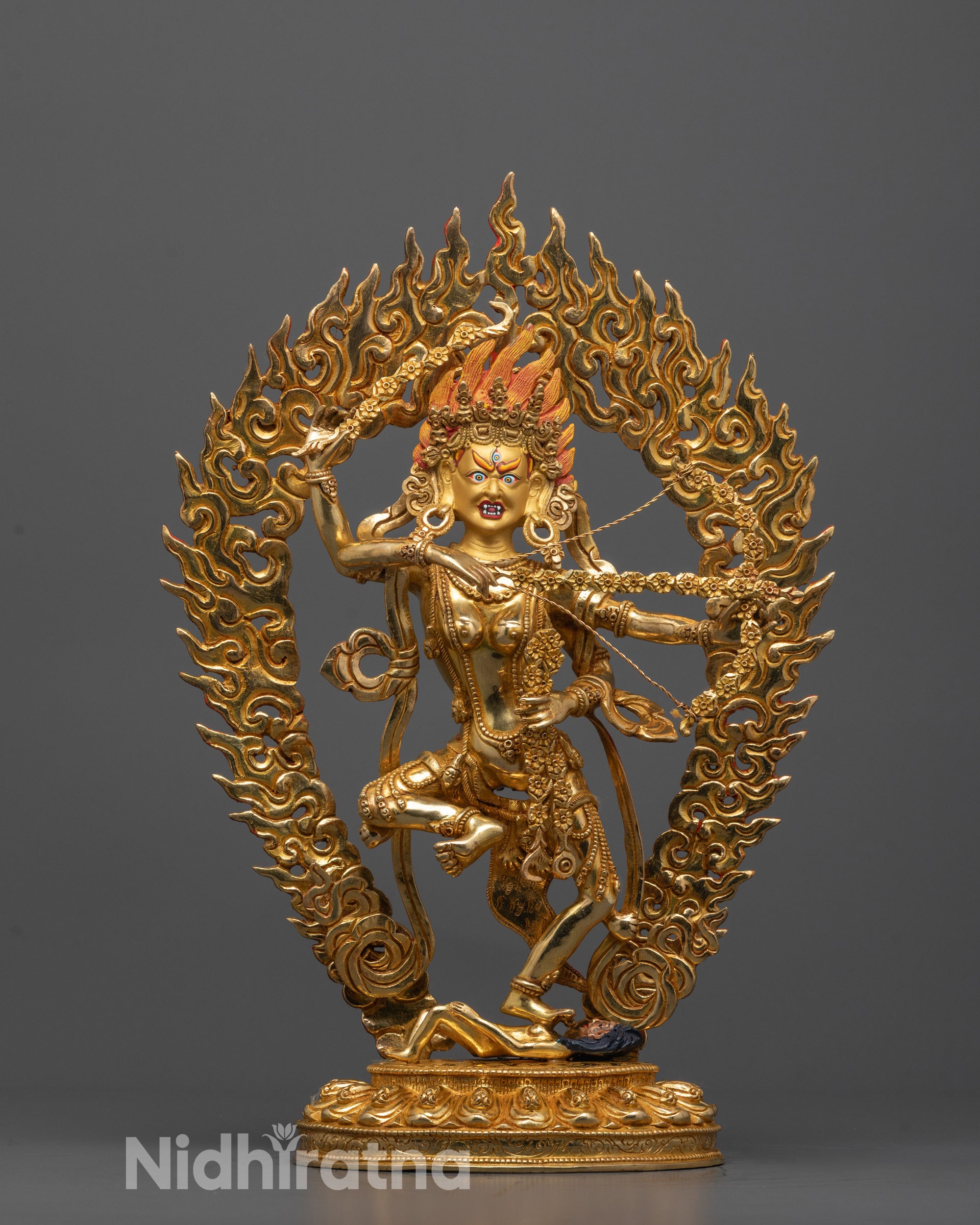 Kurukulla Statue front view with gold-gilded face and fierce stance on demon symbol