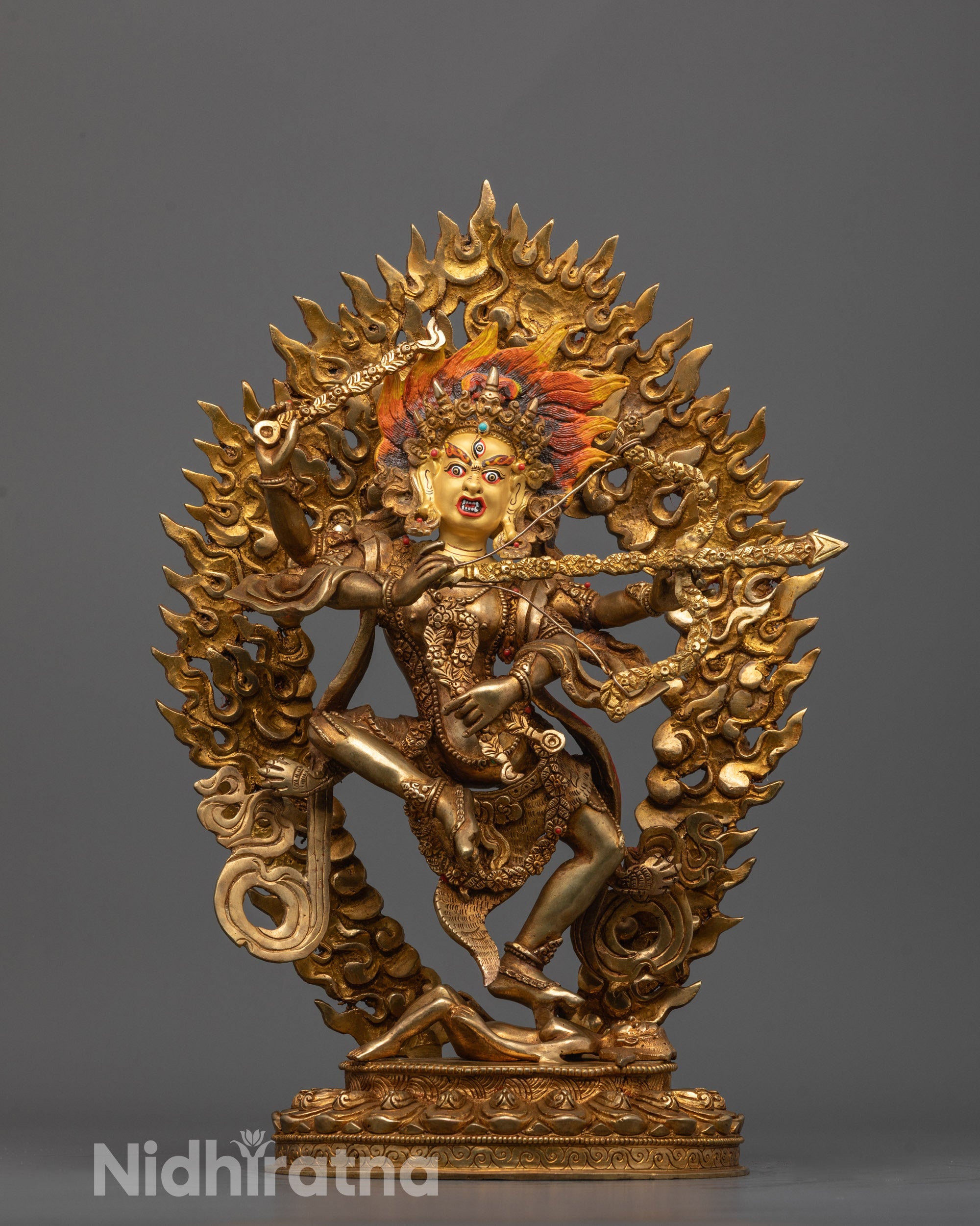 Kurukulla Statue standing over a subdued figure with a wrathful expression