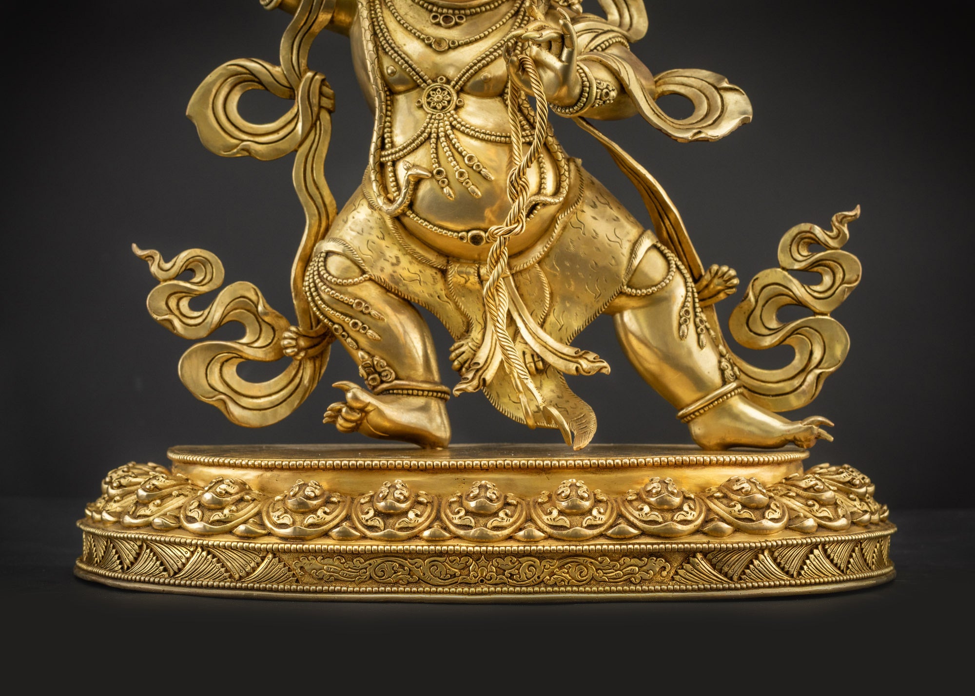 Landscape front view of Vajrapani statue seated on lotus seat
