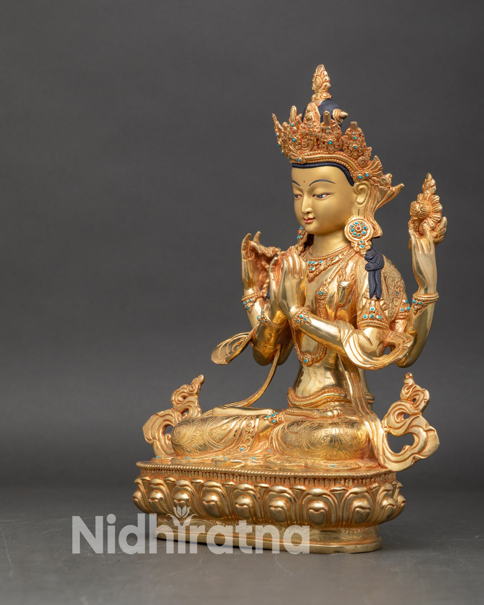 Left profile of Chenrezig Avalokiteshvara statue gold fire gilded copper Himalayan sculpture