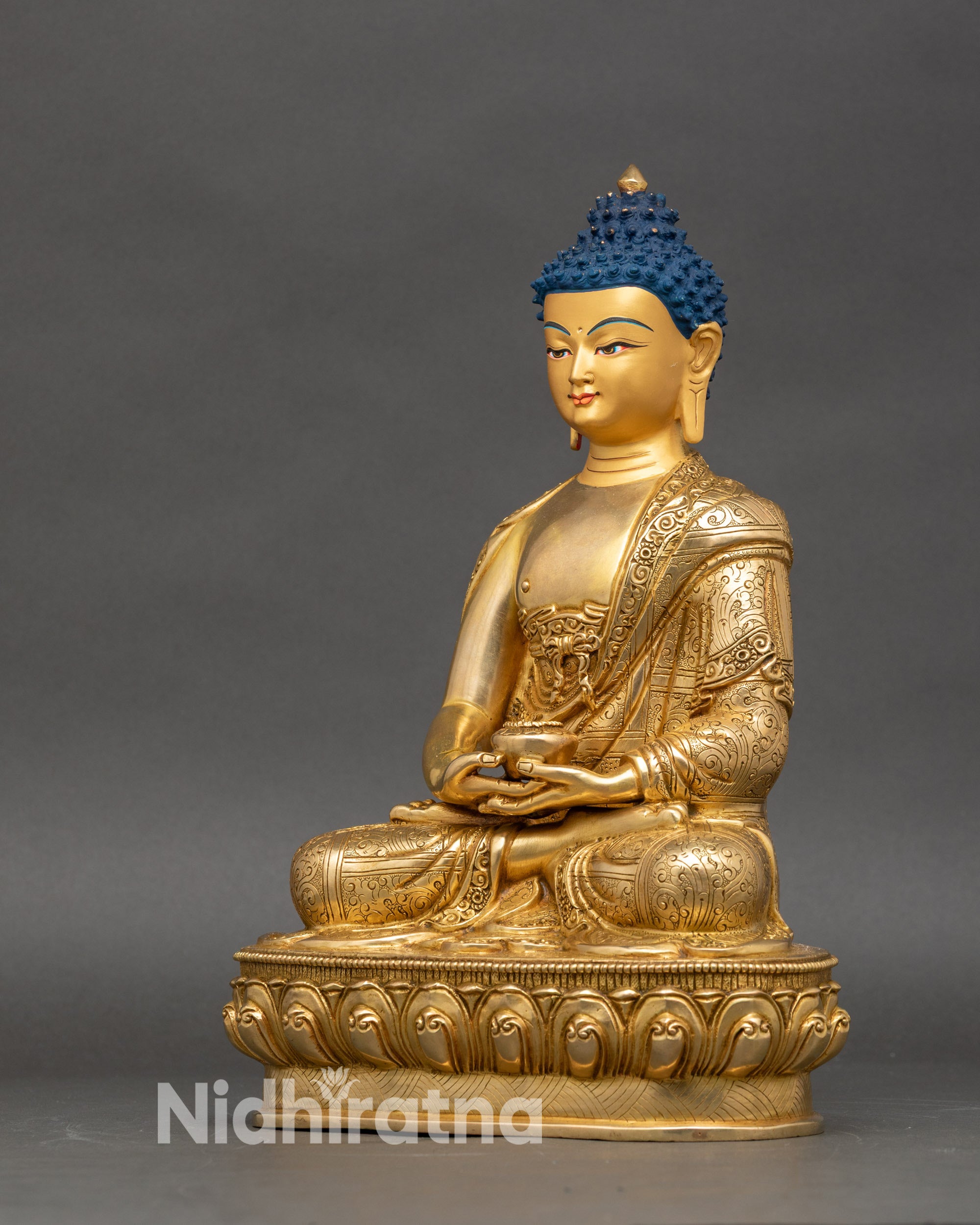 Left profile of Amitabha Buddha statue, showing meditative posture and detailed robes