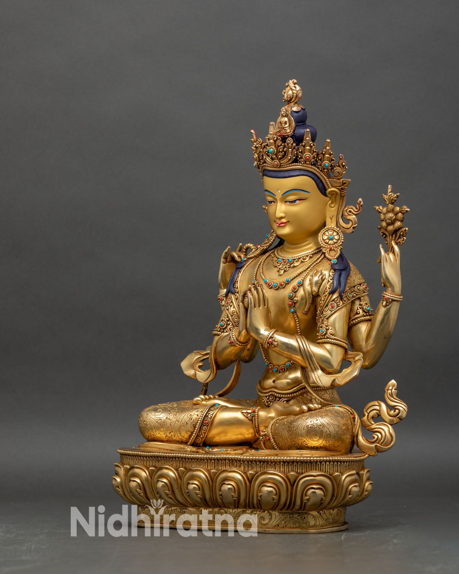 Left profile of Chenrezig statue, hand holding lotus and crystal mala, traditional Nepalese art