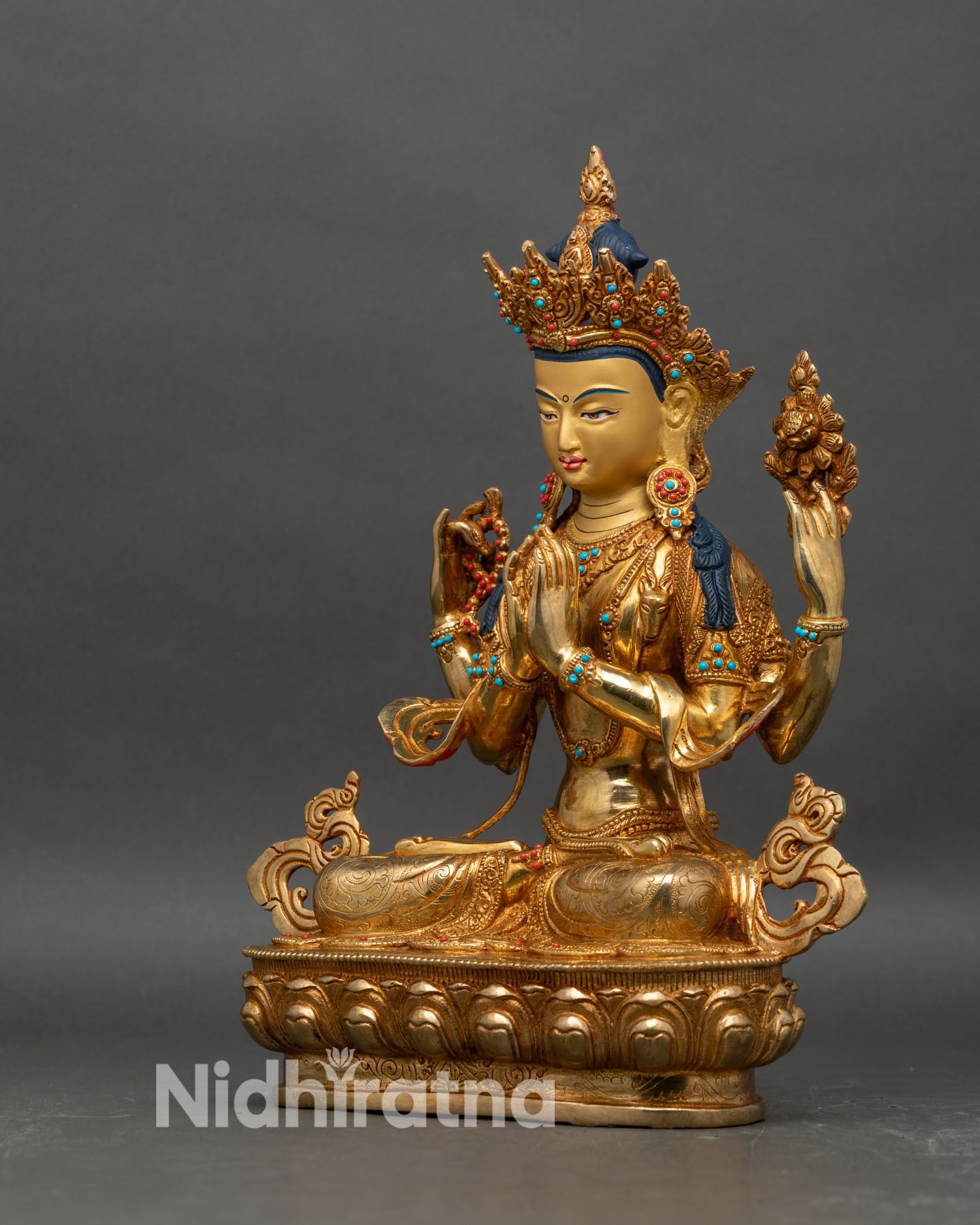 Left profile of Four-Armed Avalokiteshvara, lotus flower raised, copper and gold detailing