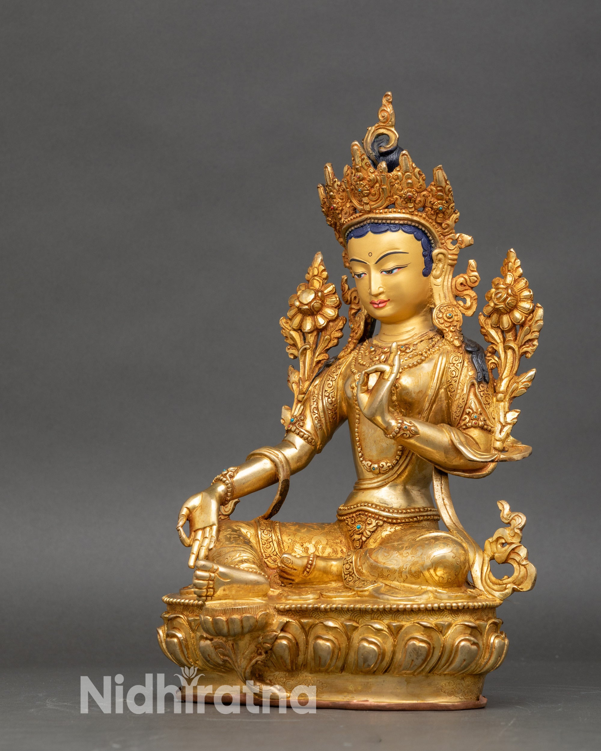 Left profile of Green Tara Bodhisattva, detailed jewelry and sacred motifs highlighted