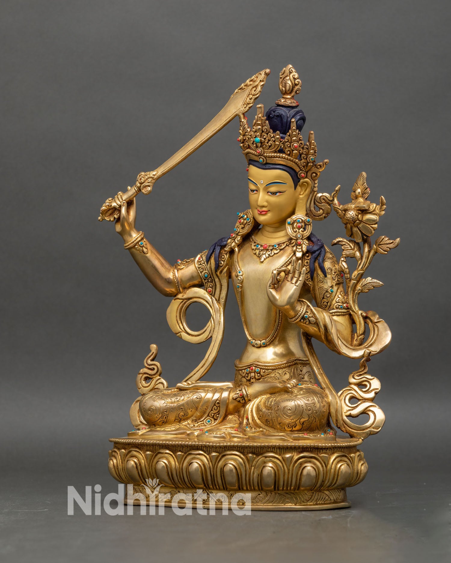 Left profile of Manjushri wisdom deity statue, gold-gilded copper Himalayan art