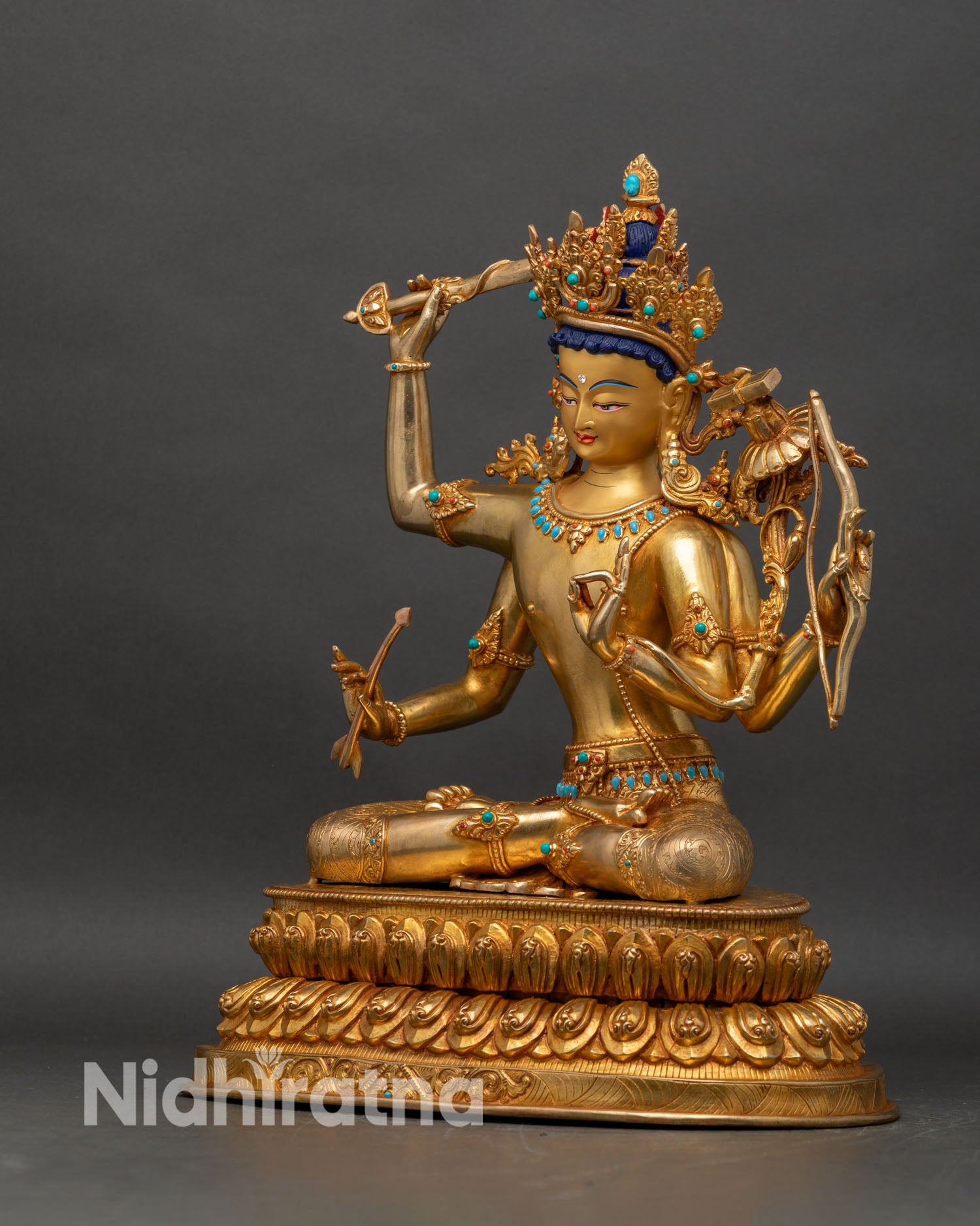 Left profile of Maha Manjushri statue with intricate copper carving and fire-gilded surface