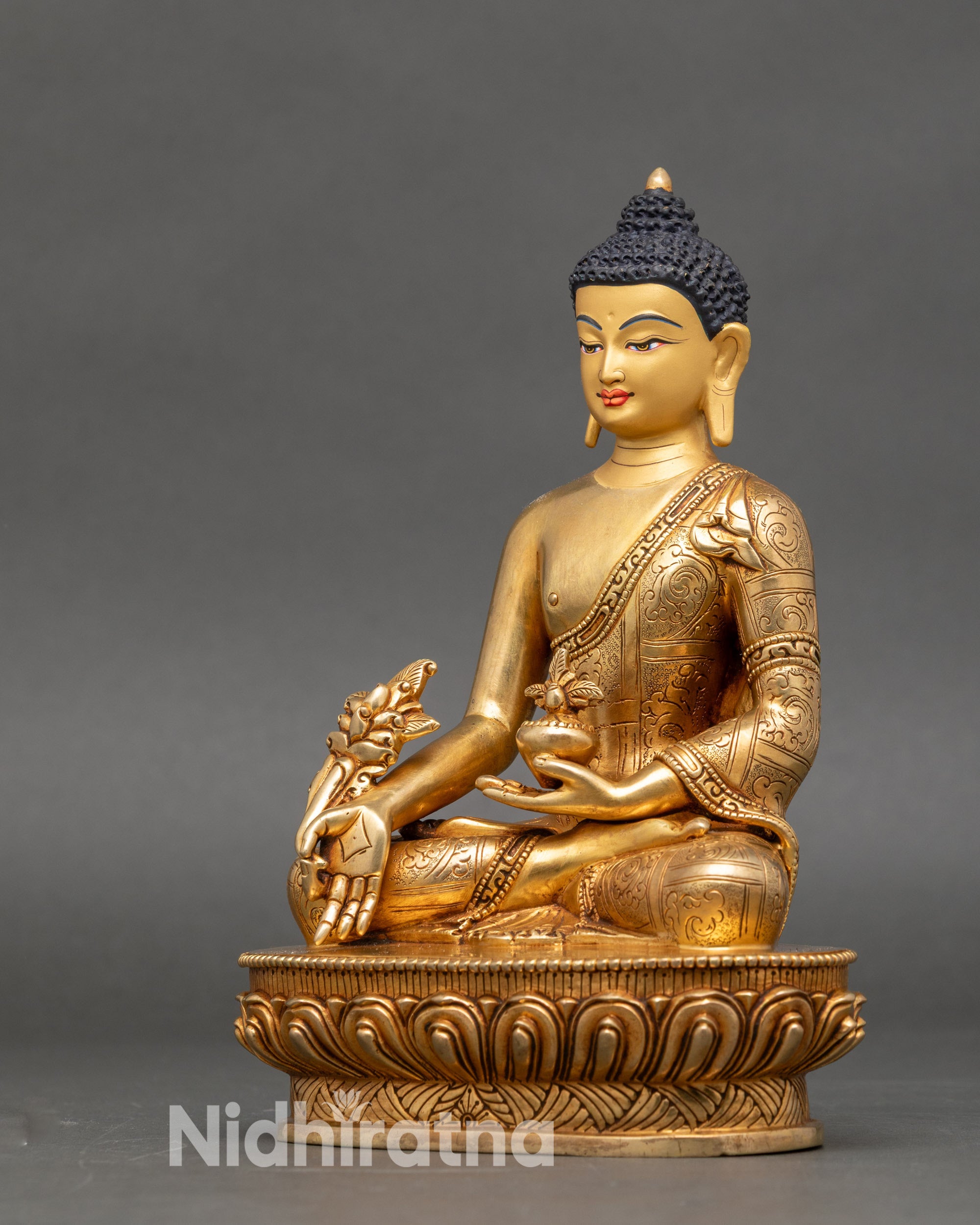 Left side view of Medicine Buddha statue with detailed lotus seat and engraved robes