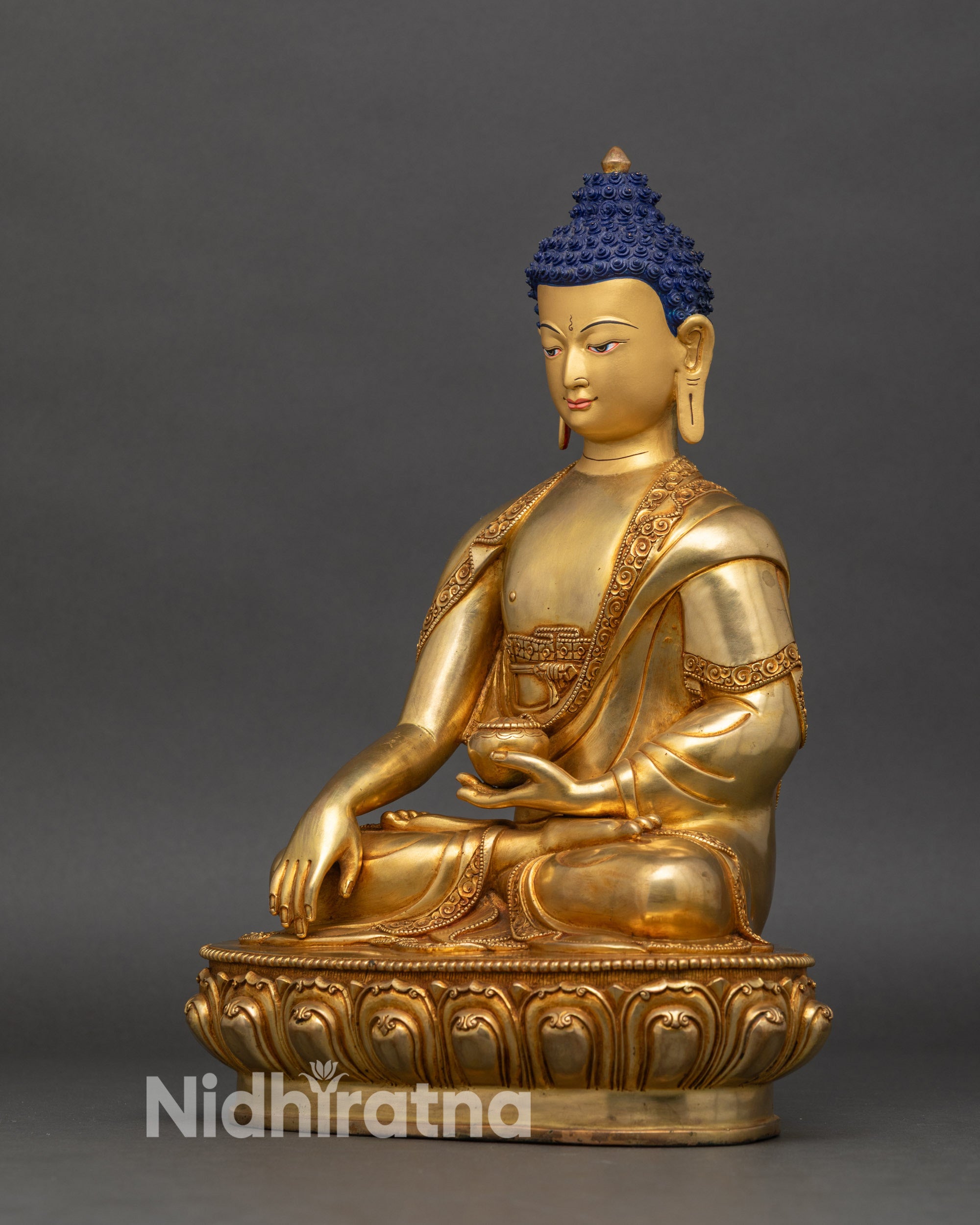 Left side view of Shakyamuni Buddha figurine, copper with gold fire-gilding and detailed robe