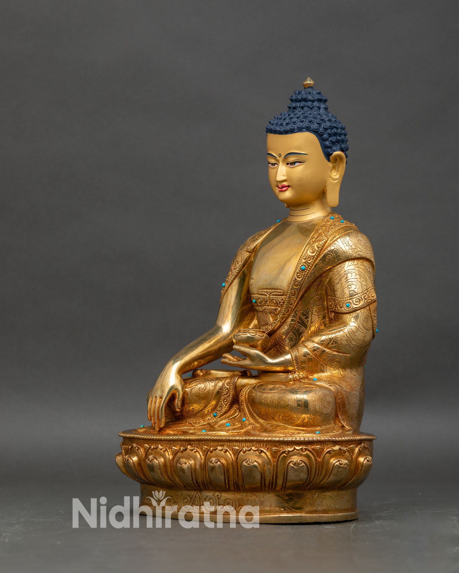 Left side view of Shakyamuni Buddha statue, gold fire-gilded lotus pedestal