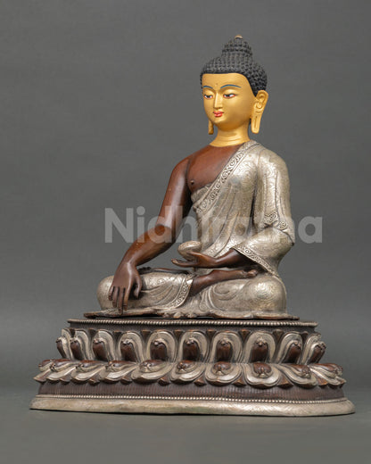 Left side view of handmade Shakyamuni Buddha sculpture with copper tones and silver-plated robe details