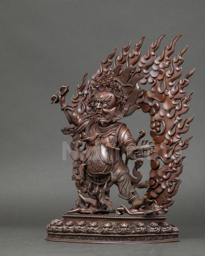 Left-side view of Guru Dragpo Statue showing wrathful posture and subduing human figures