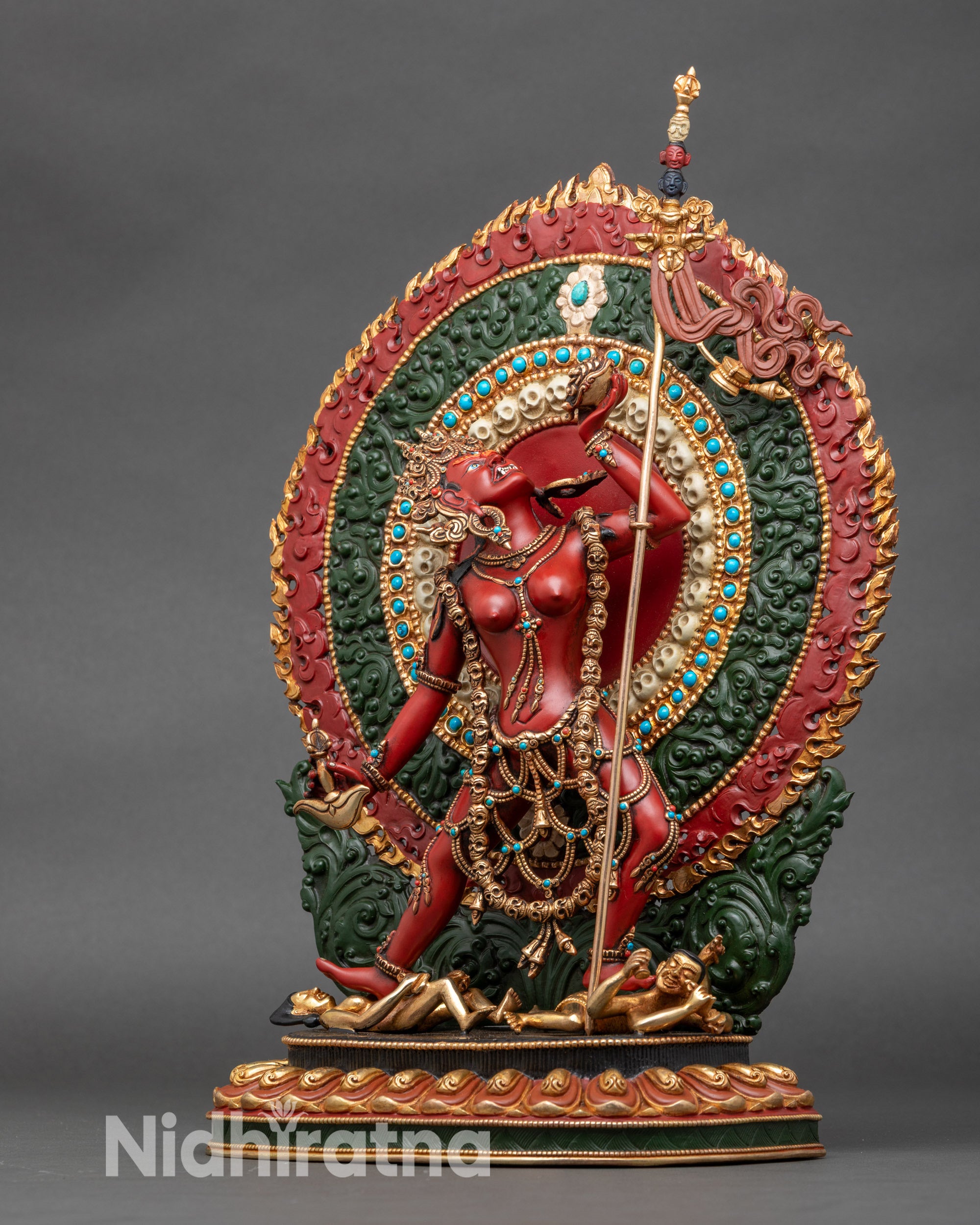 Left-side view of Vajrayogini figurine, copper statue with gold accents