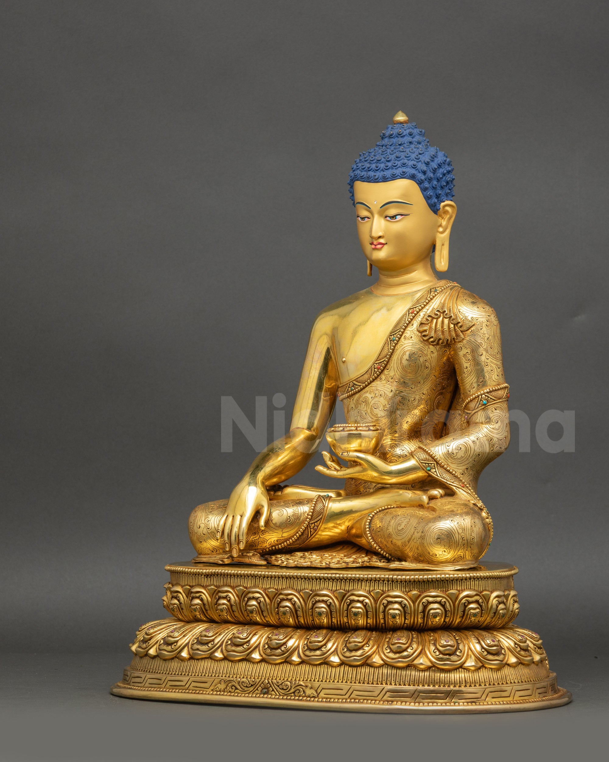 Left-side view of handcrafted Buddha with gold fire-gilded copper surface
