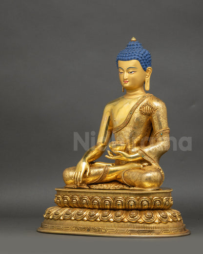 Left-side view of handcrafted Buddha with gold fire-gilded copper surface
