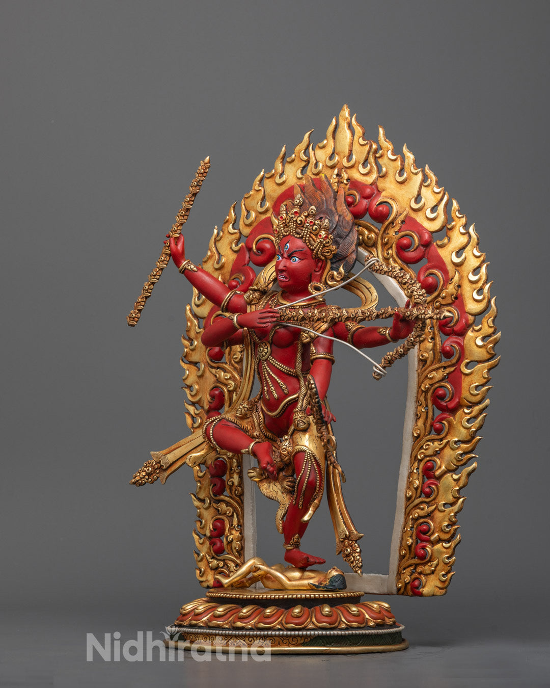 Left angle view of Kurukulla statue in dynamic posture, highlighting ornate crown, arm gestures