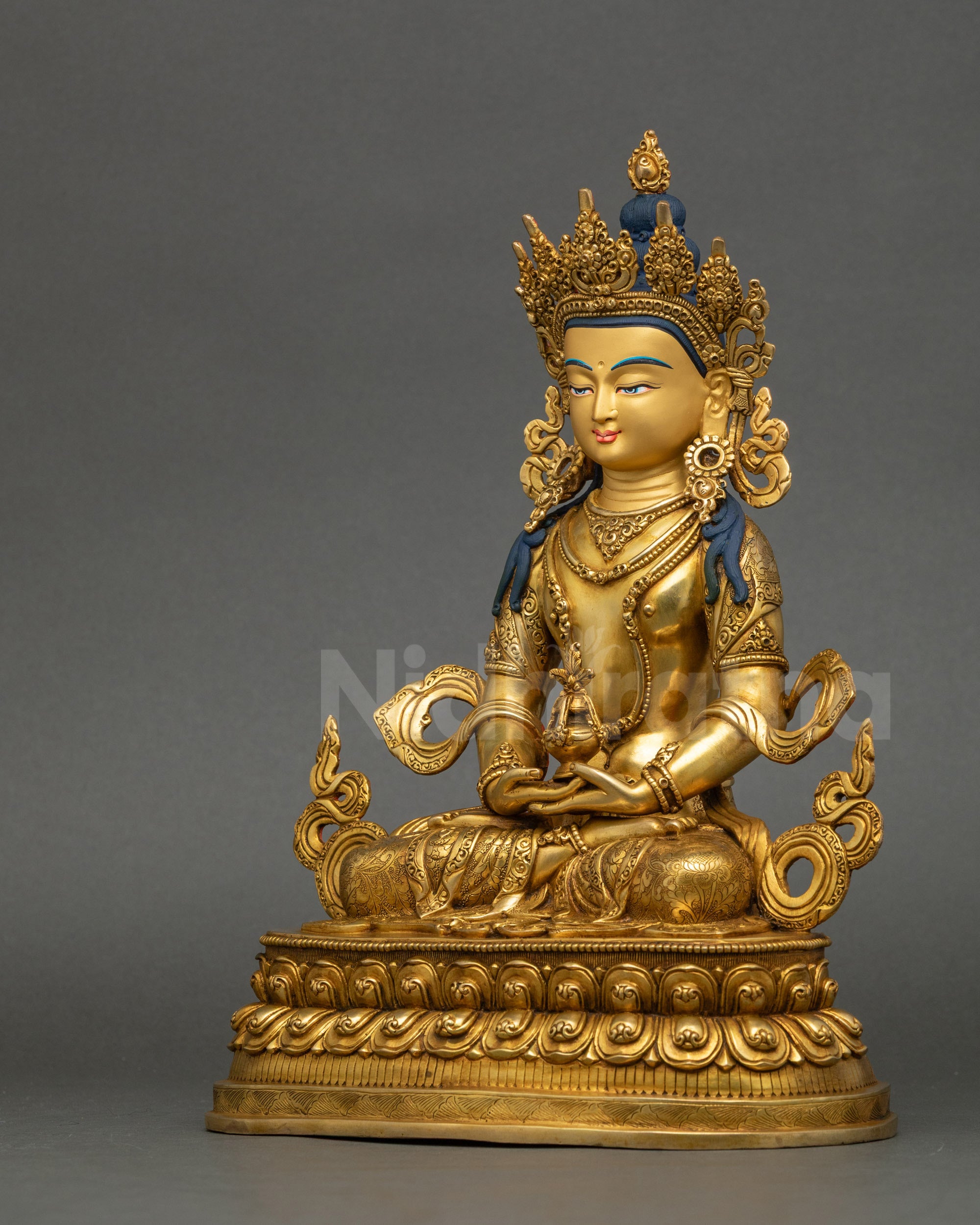 Left profile of Amitayus statue showing gold fire-gilding and lotus throne