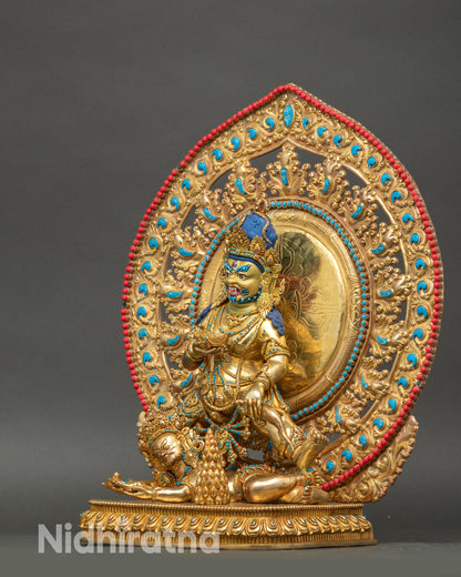 Left profile of Black Dzambhala statue showing blazing wisdom flame halo