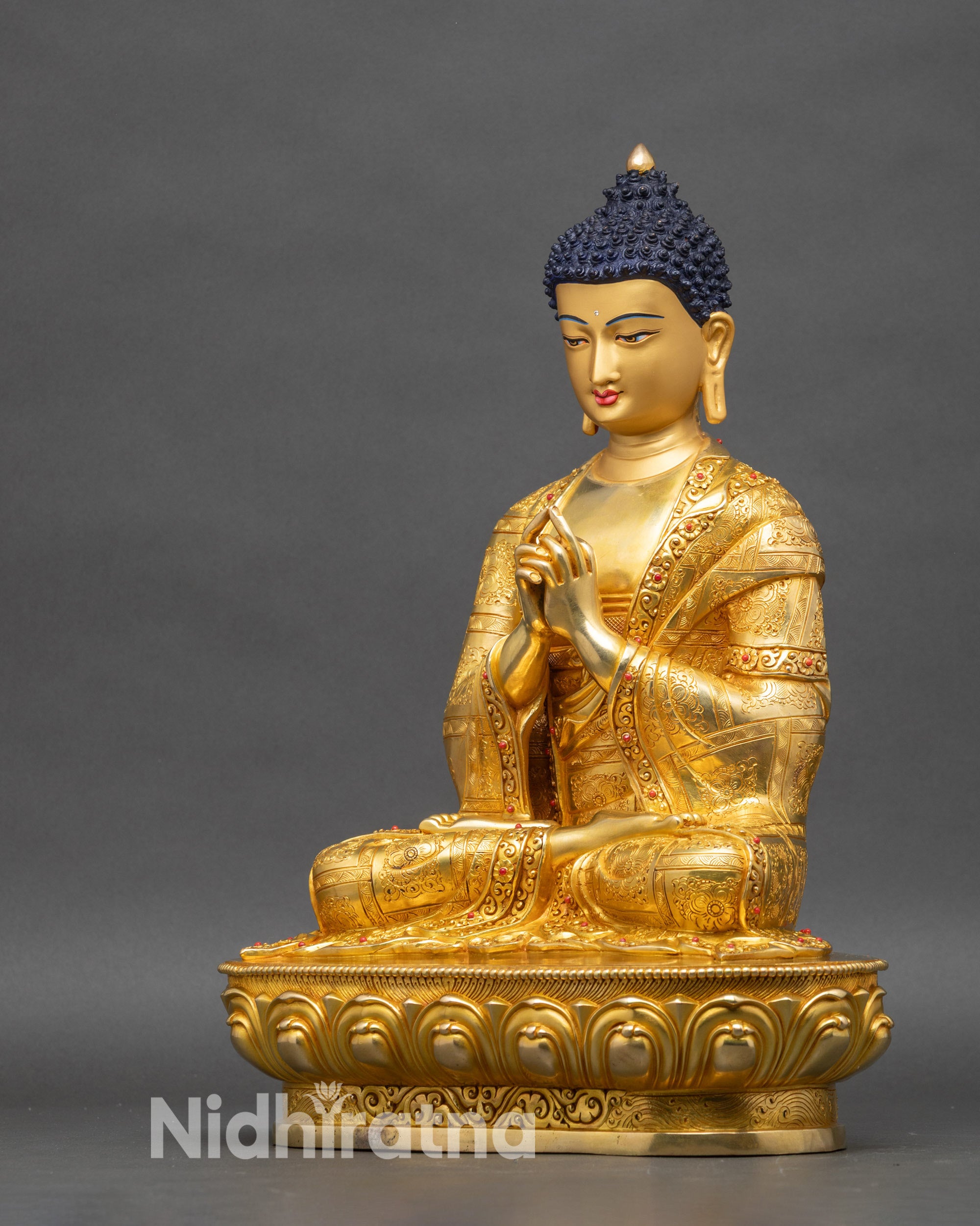 Left profile of Cosmic Vairocana Buddha statue with floral motif and gold finish