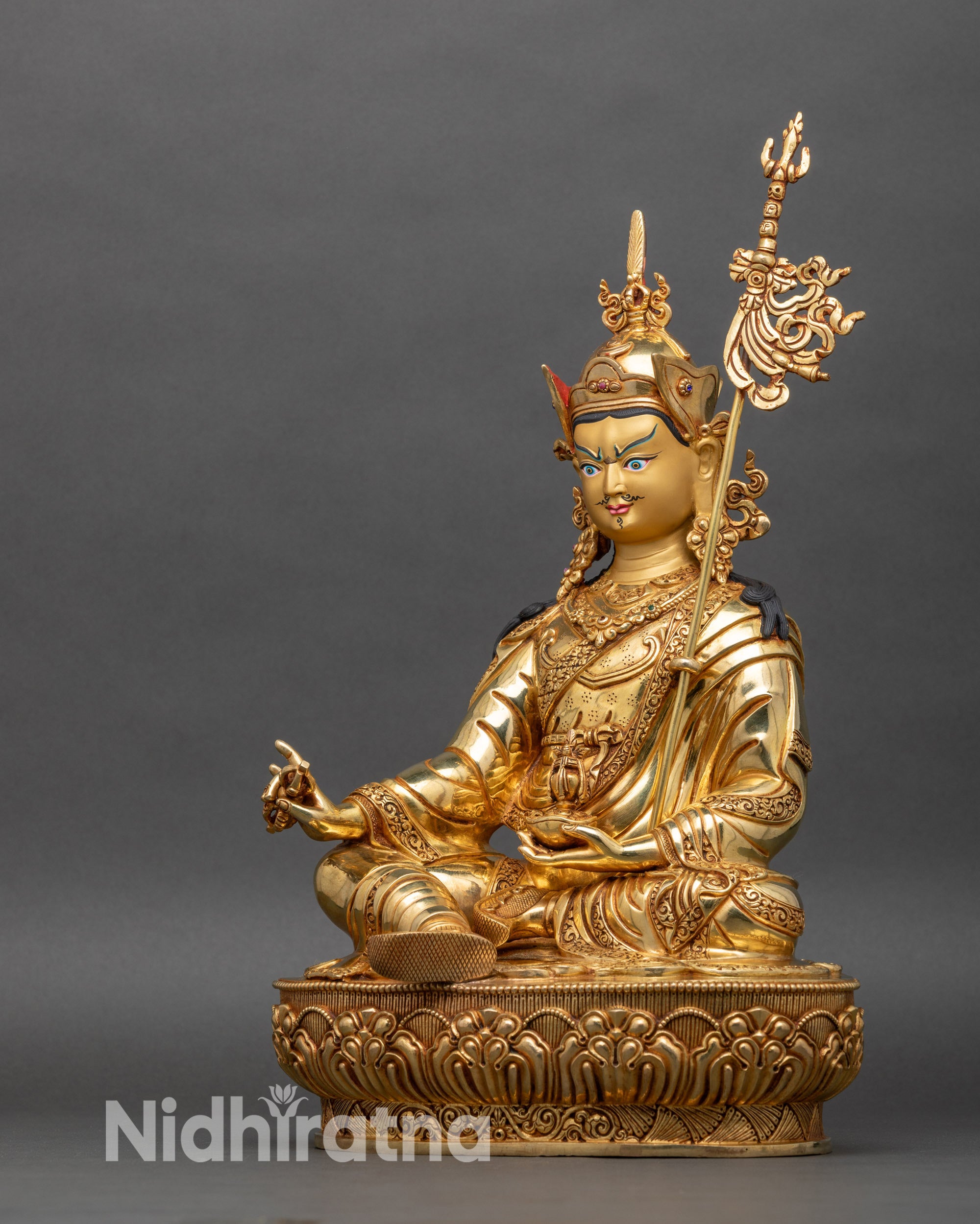 Left profile of Guru Padmasambhava statue showing intricate details and lotus hat
