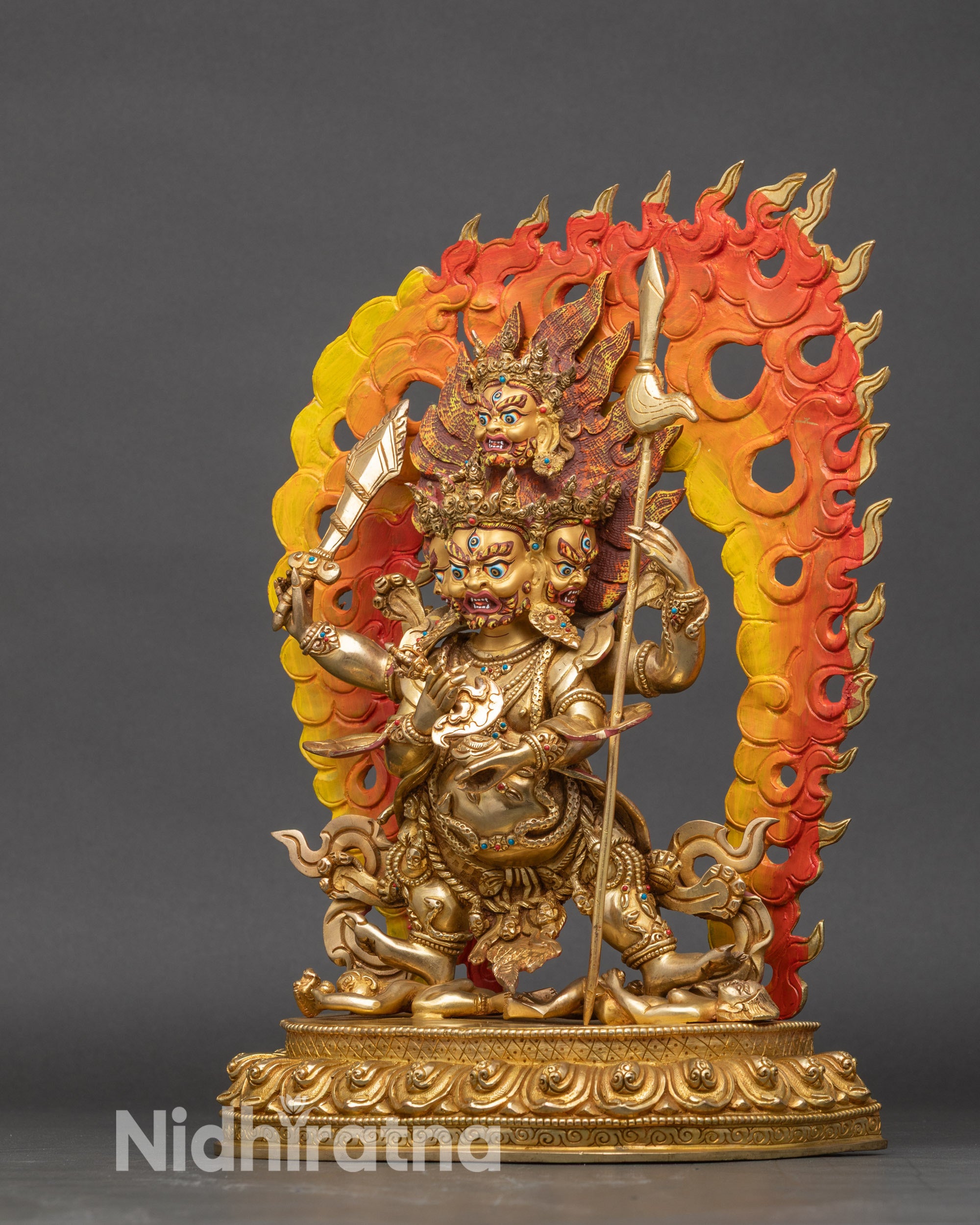 Left profile of Mahakala statue highlighting detailed robes and semi-precious inlays
