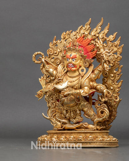 Left profile of Mahakala statue, showing detailed tiger-skin robes and halo flames