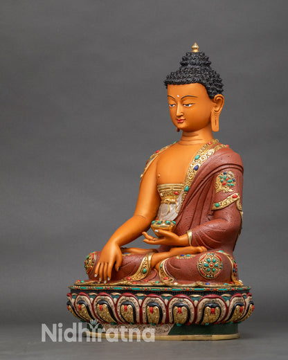 Left profile of Shakyamuni Buddha statue on lotus base, gold-gilded Nepalese artwork