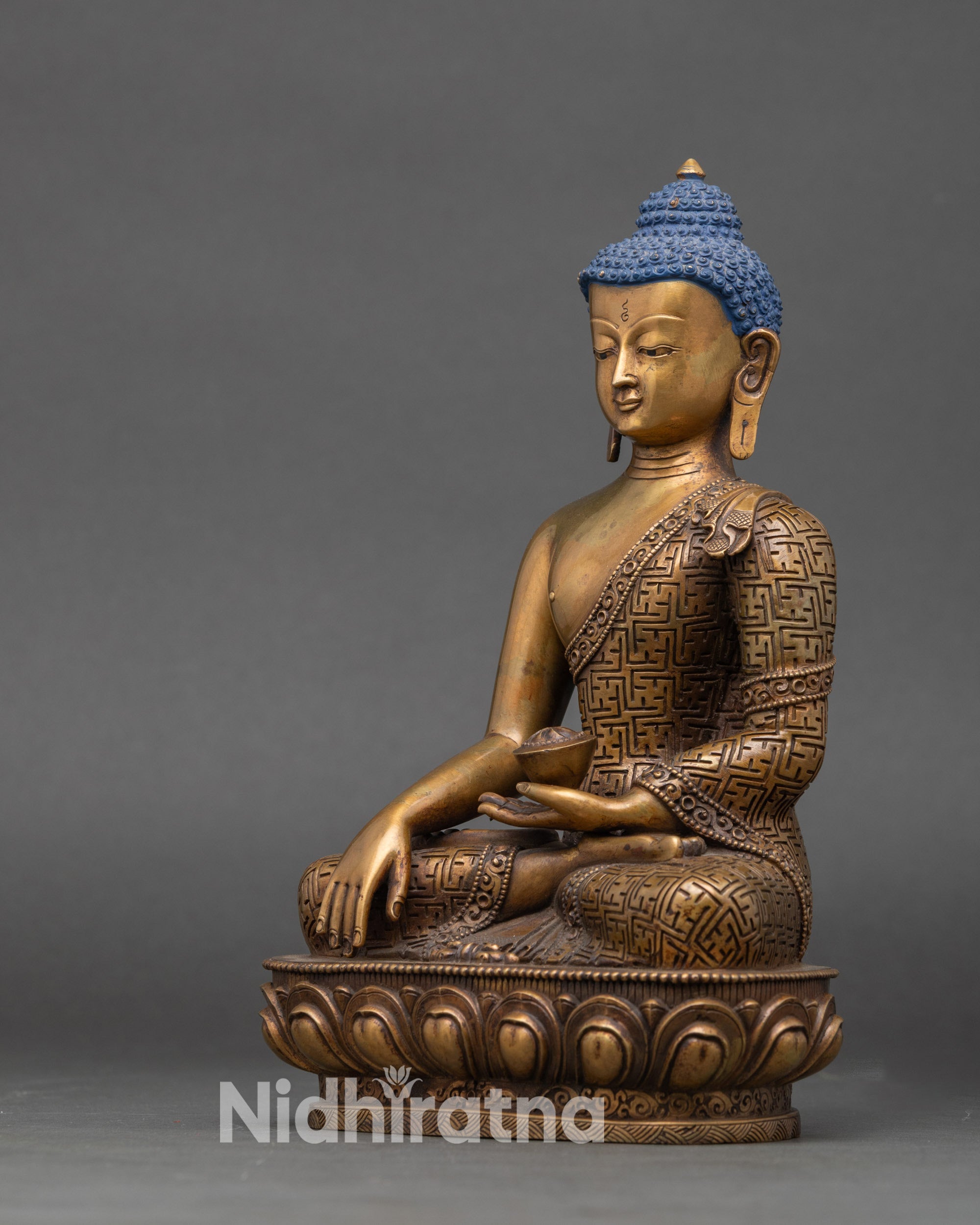 Left profile of Shakyamuni Buddha statue showcasing sacred begging bowl and details
