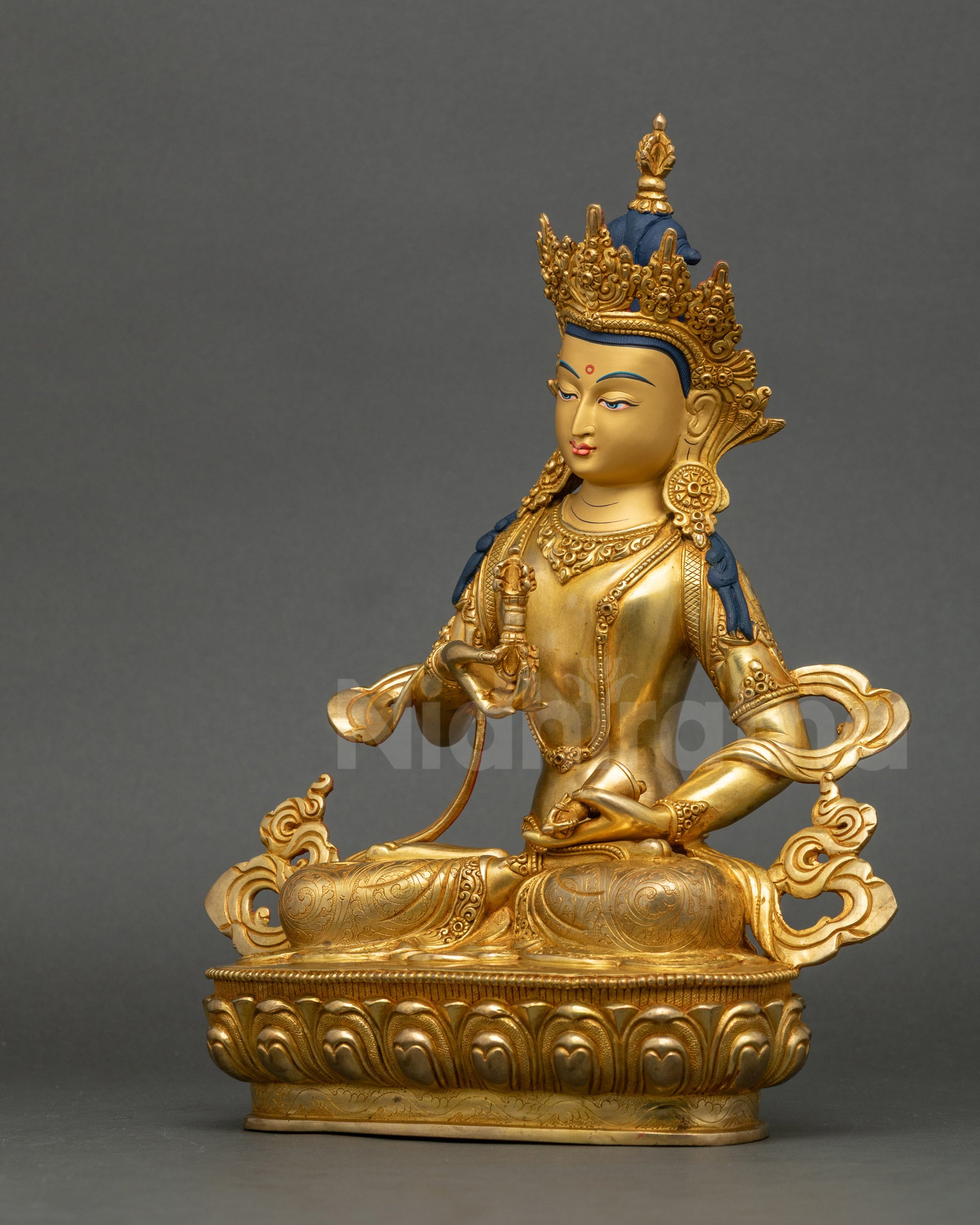 Left profile of Vajrasattva meditation statue highlighting carved garments and lotus base