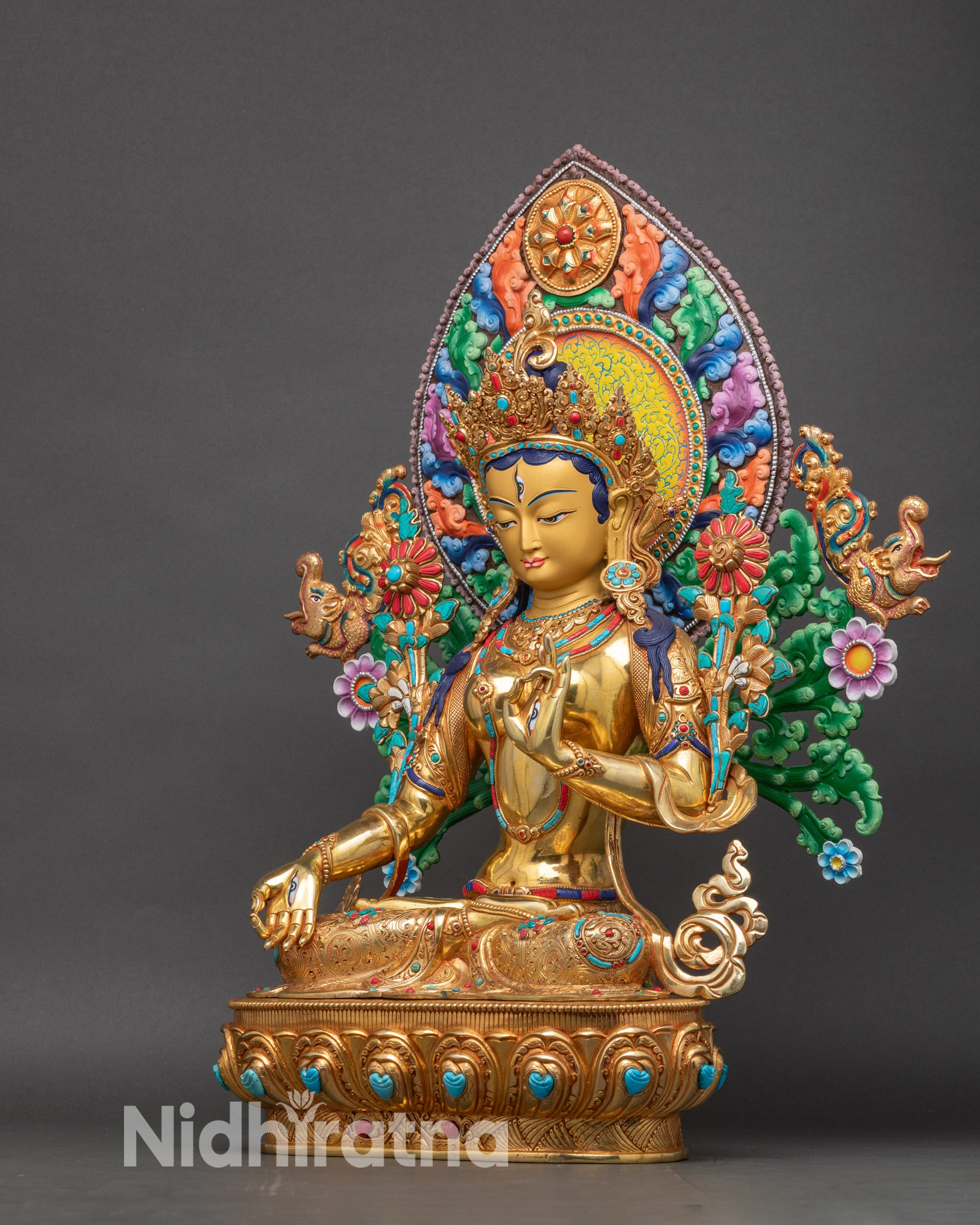 Left profile of White Tara statue, handcrafted Nepalese Buddhist art with utpala flower