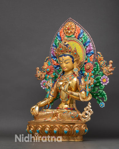 Left profile of White Tara statue, handcrafted Nepalese Buddhist art with utpala flower