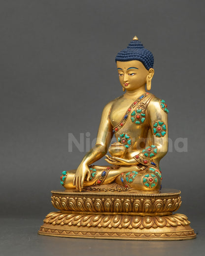 Left side of Nepalese Shakyamuni Buddha Statue with begging bowl and semi-precious robe details