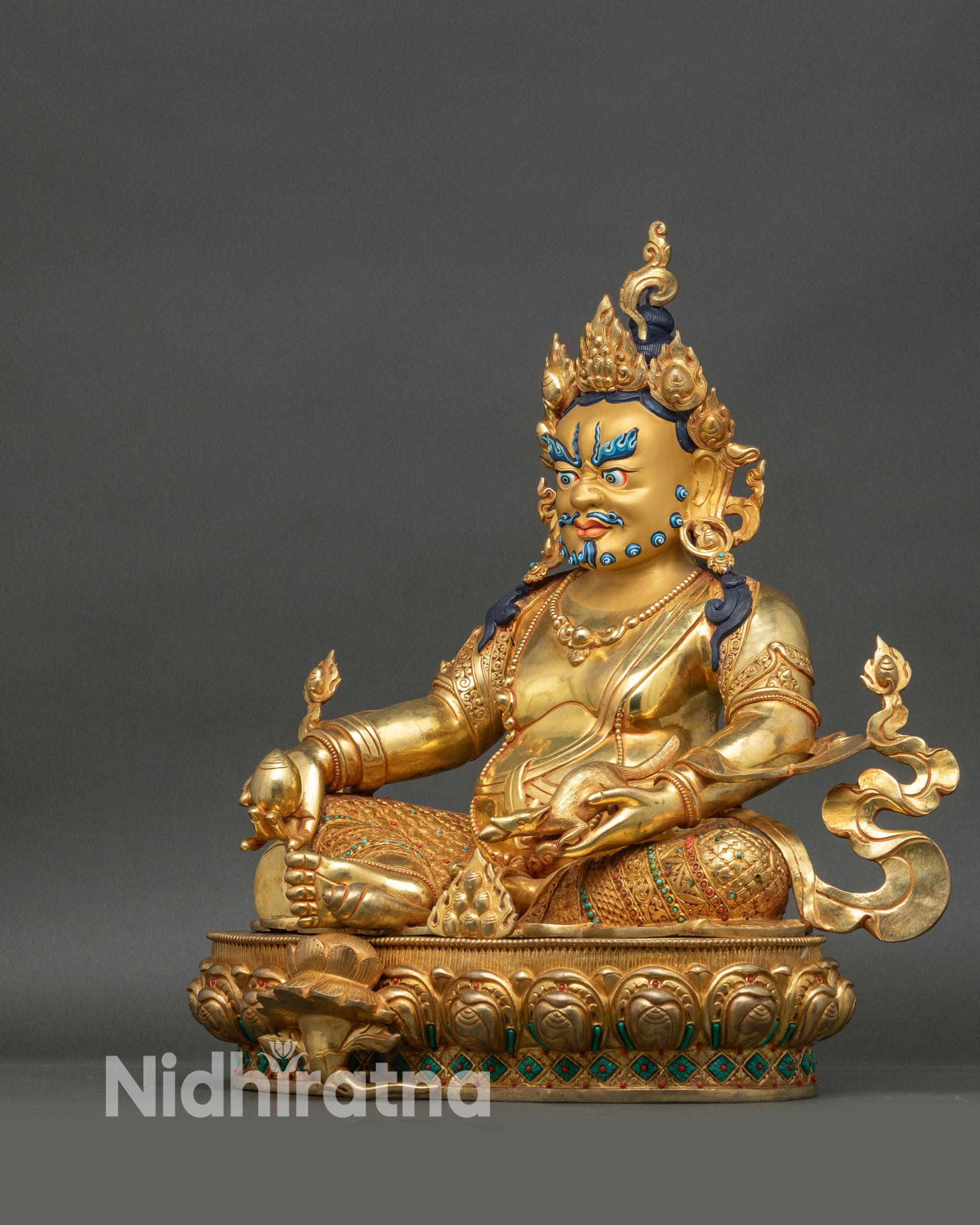 Left side profile of Dzambhala wealth deity statue with ornate crown and jewelry