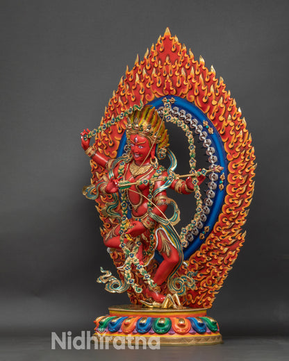 Left side profile of Kurukulla statue with four arms and ritual attributes