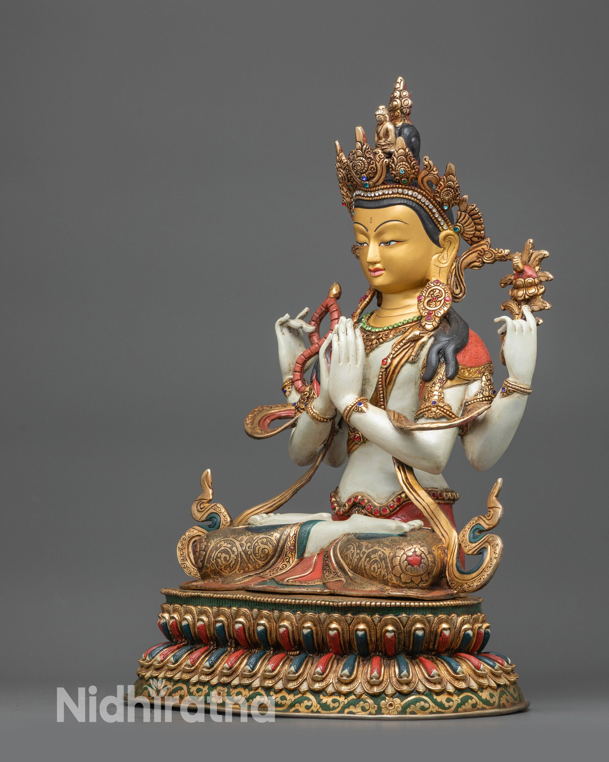 Left side view Chenrezig statue with white body and intricate carvings on lotus base