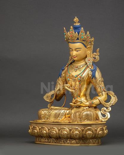 Left side view Vajrasattva statue gold gilded face holding vajra and bell