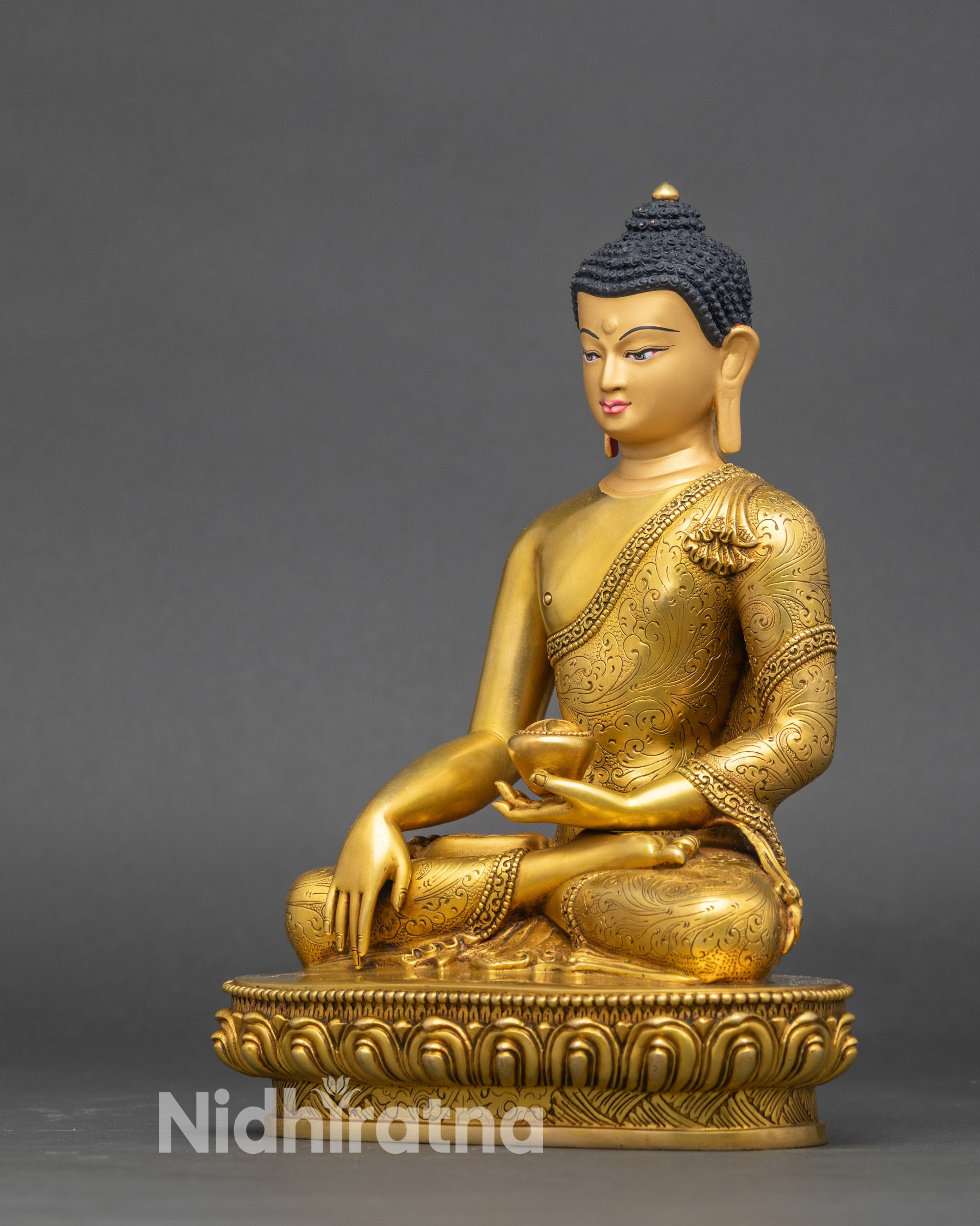 Left side view capturing the statue’s pose, detailed robes, and shimmering gold fire-gilded finish.