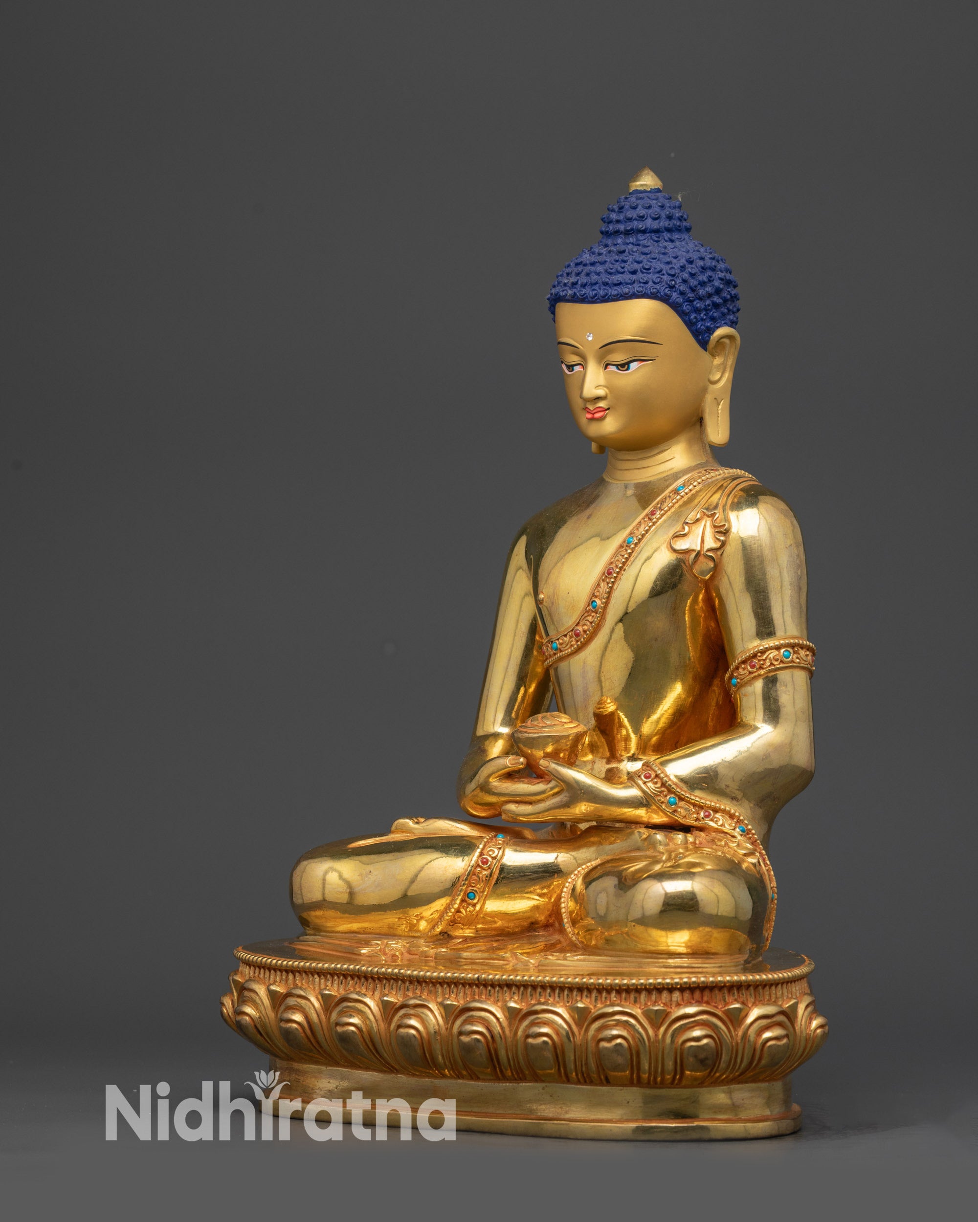 Left side view of Amitabha Buddha statue showing monk's robe details and gold gilding
