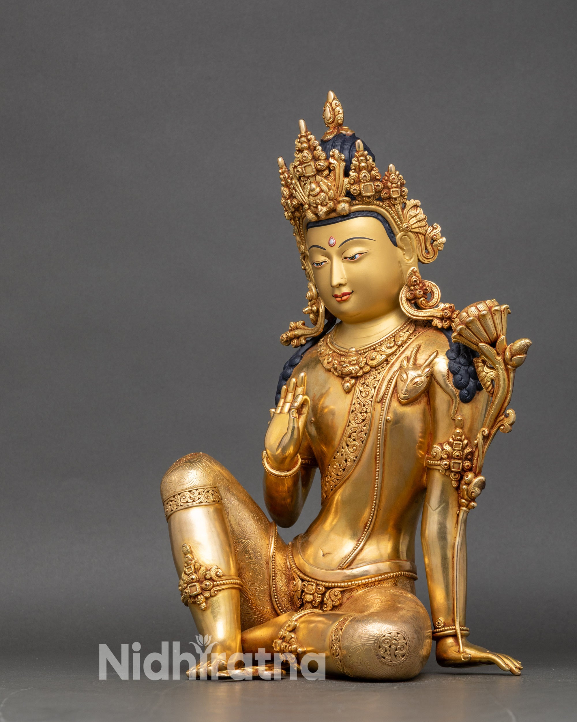 Left side view of Avalokiteshvara statue with deer skin and armlets